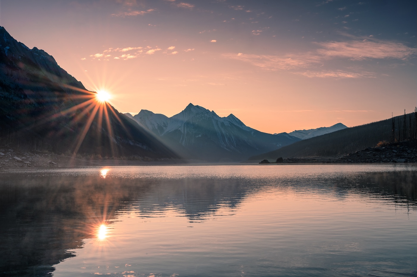 Sunrise on mountain with foggy in Medicine lake at Jasper