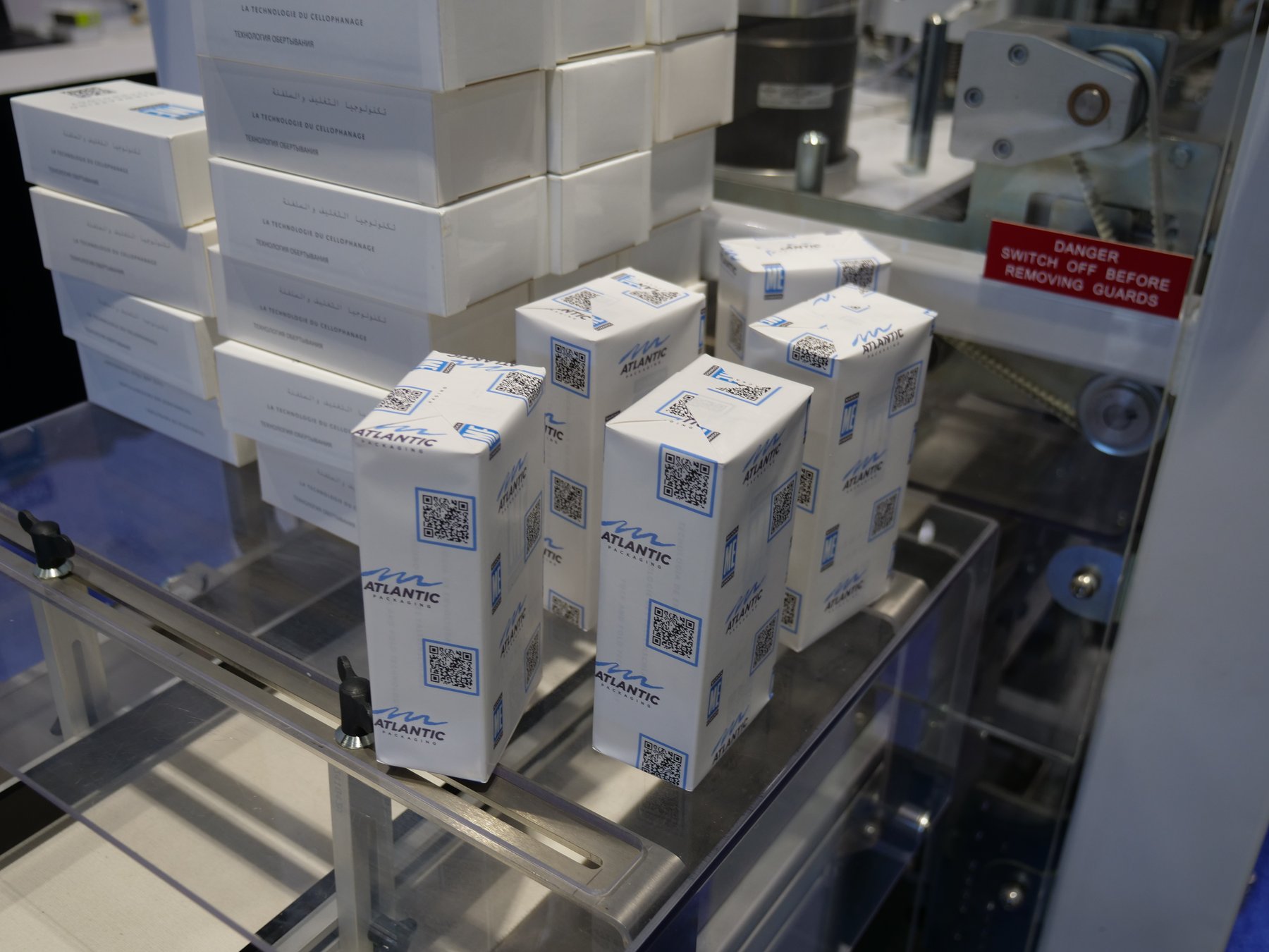 Cartons overwrapped in Atlantic-printed paper on Marden Edwards equipment at PACK EXPO 2026